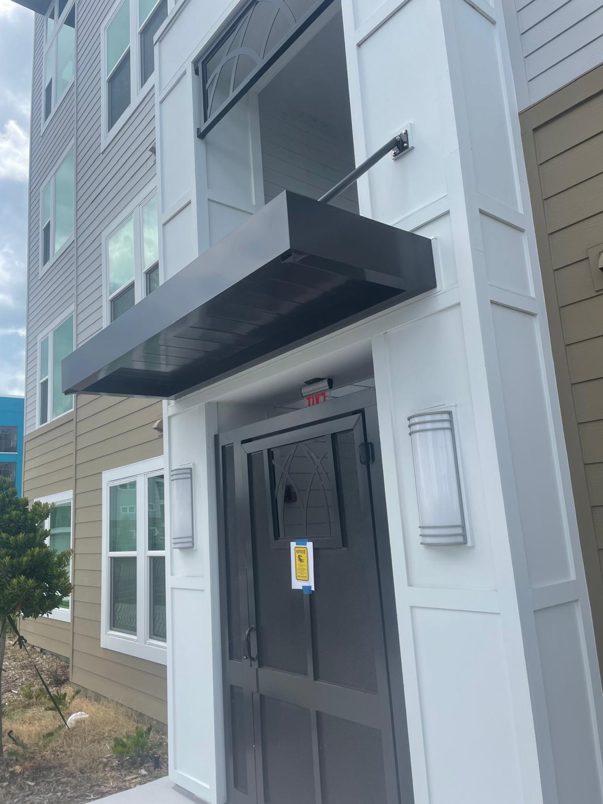 Steel canopy over secured building entrance