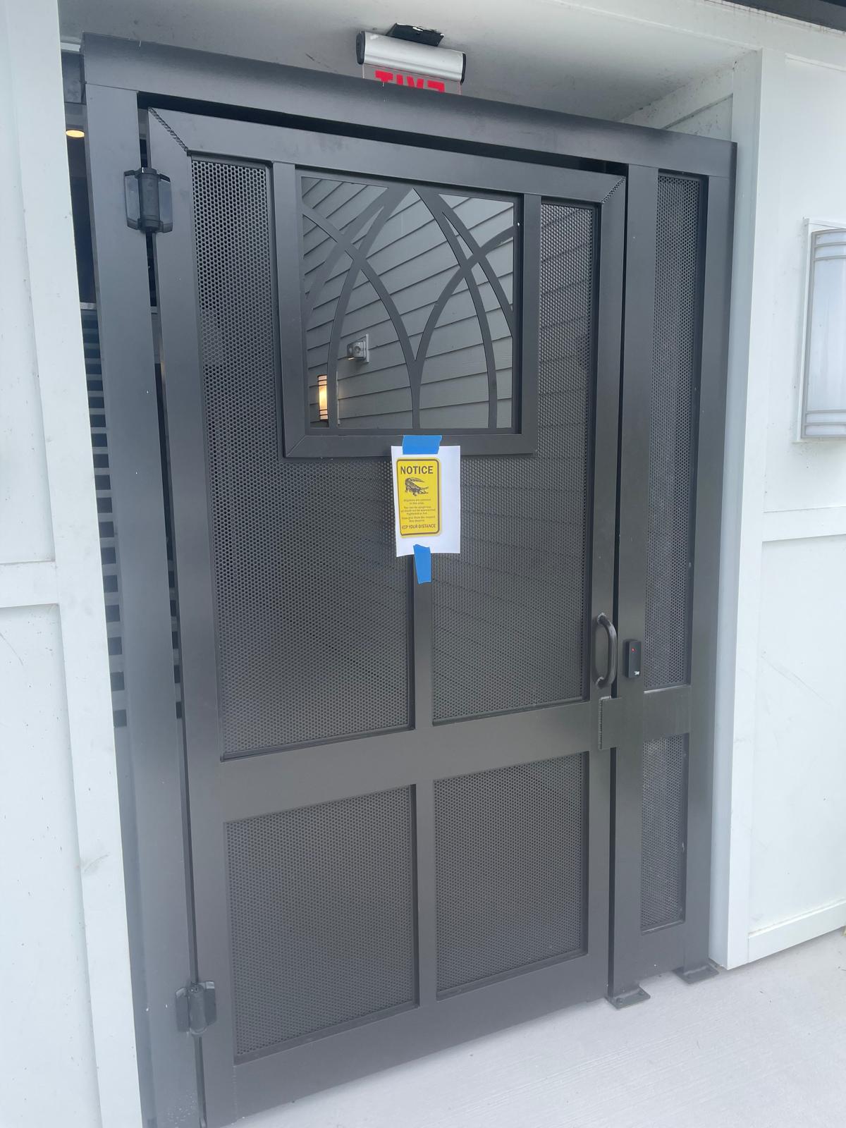 Custom security gate with arched glass detail
