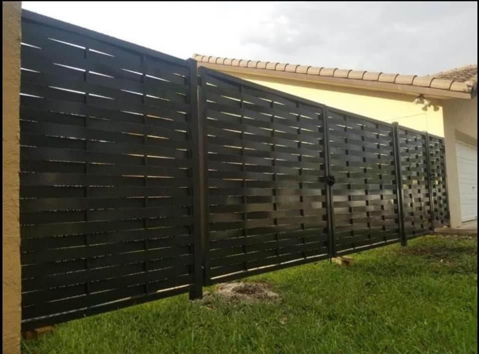 Decorative privacy fence with woven steel panels