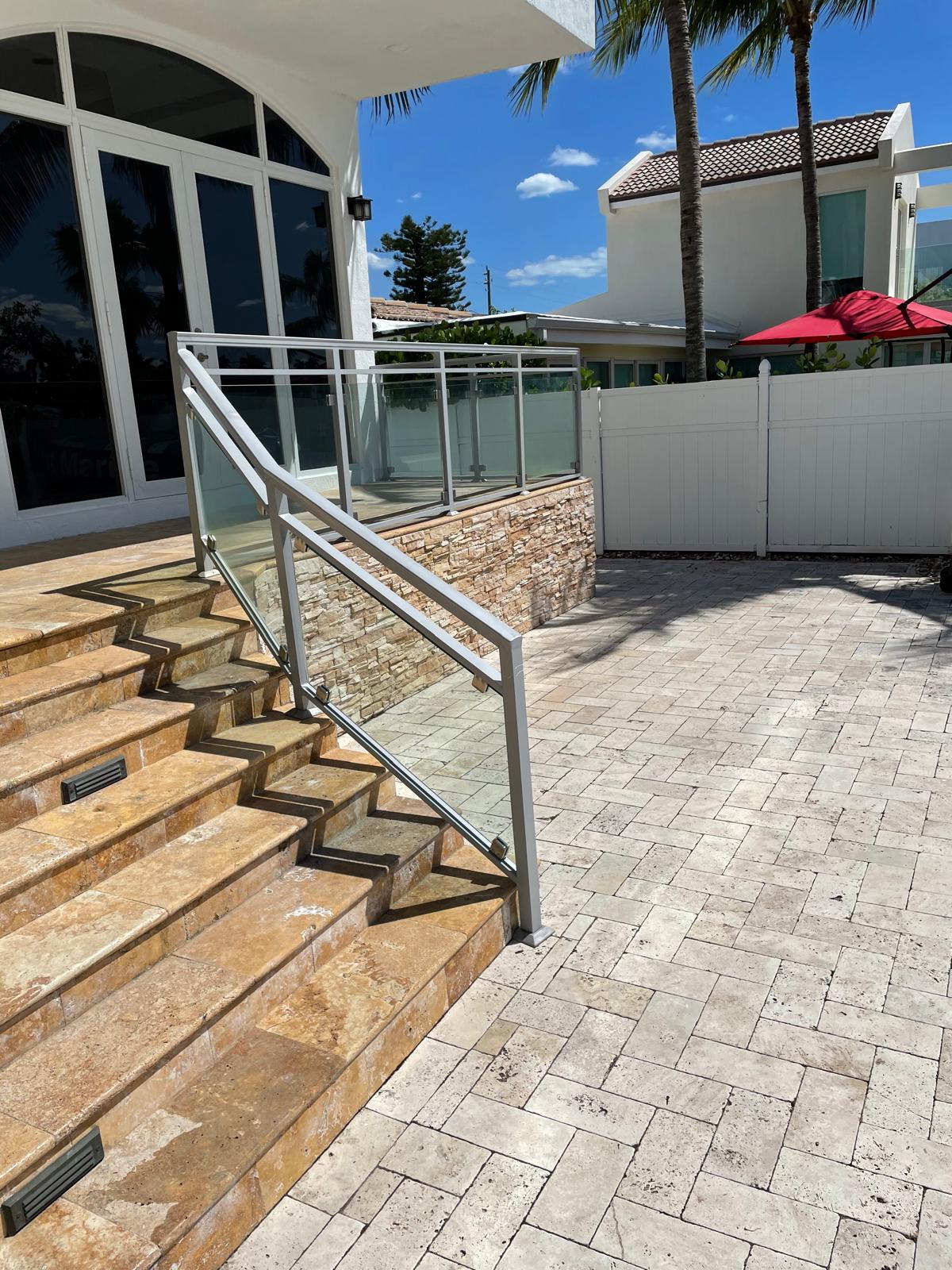 Glass railing system on outdoor staircase, residential coastal home