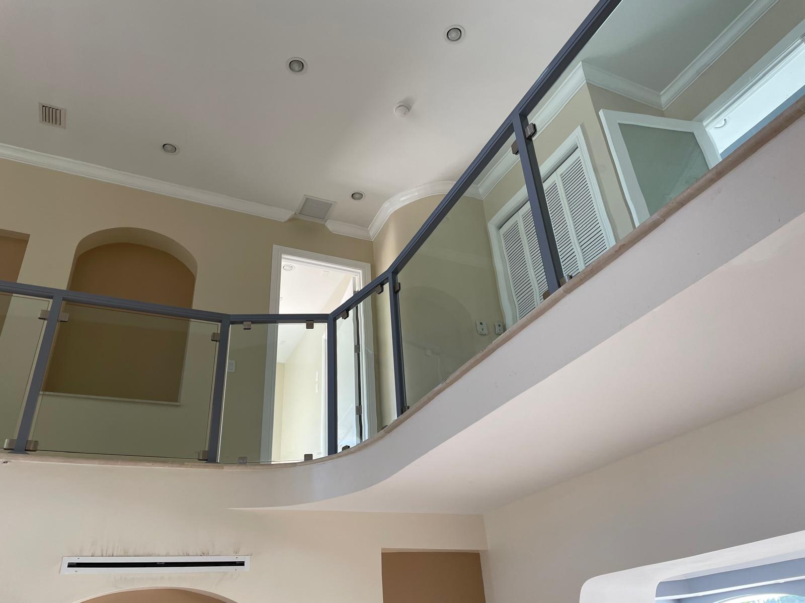 Curved interior glass railing with charcoal frame