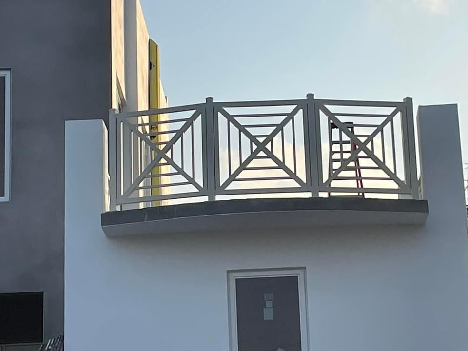 Custom white exterior railing with geometric pattern