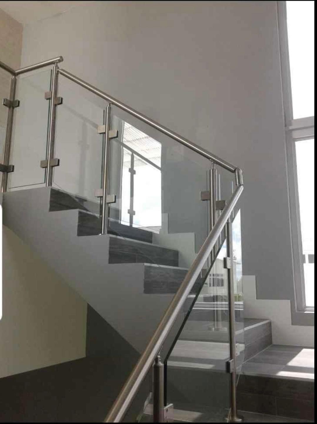 Modern glass staircase with stainless steel posts